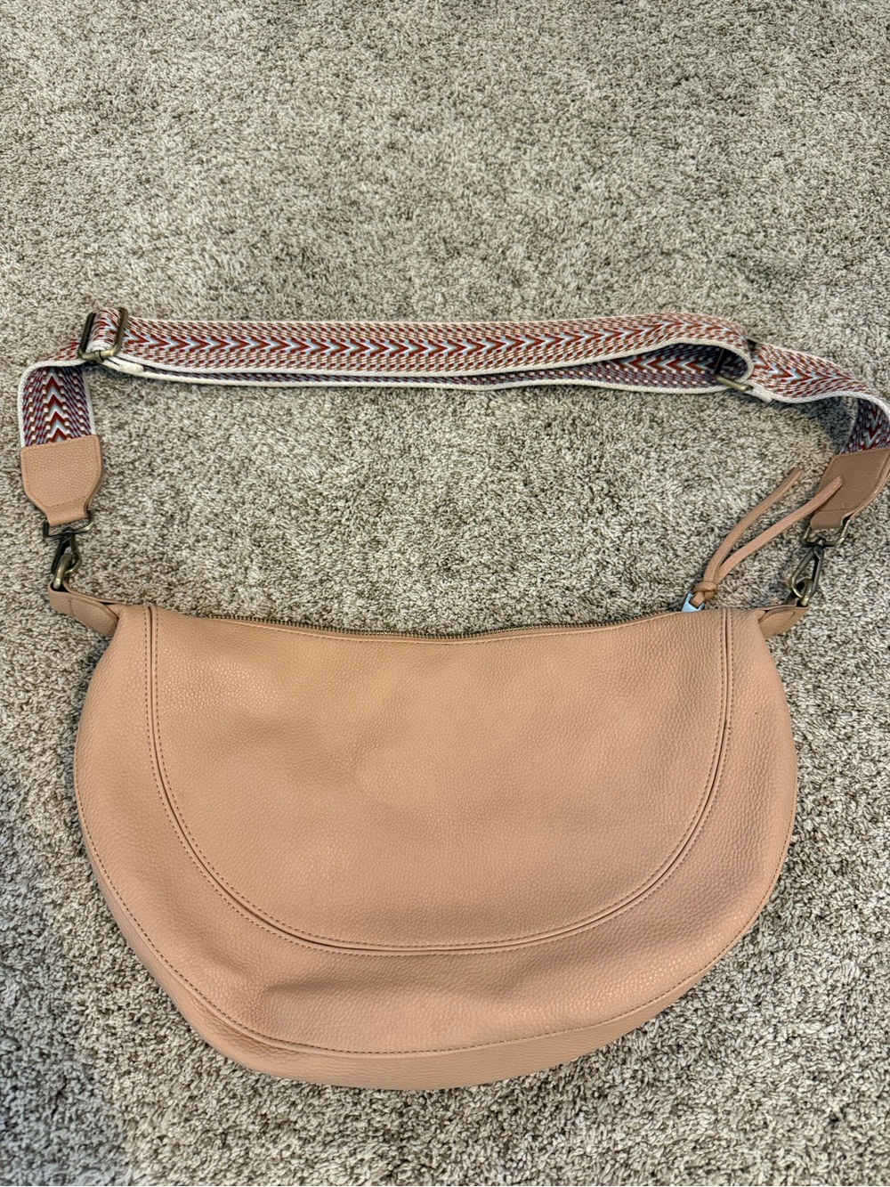 Neutral Tan Leather Crescent Shoulder Bag with Adjustable Patterned Strap